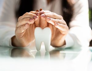 a person covering a model of a tooth