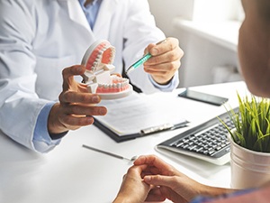 A patient consulting a dentist about implant denture treatment