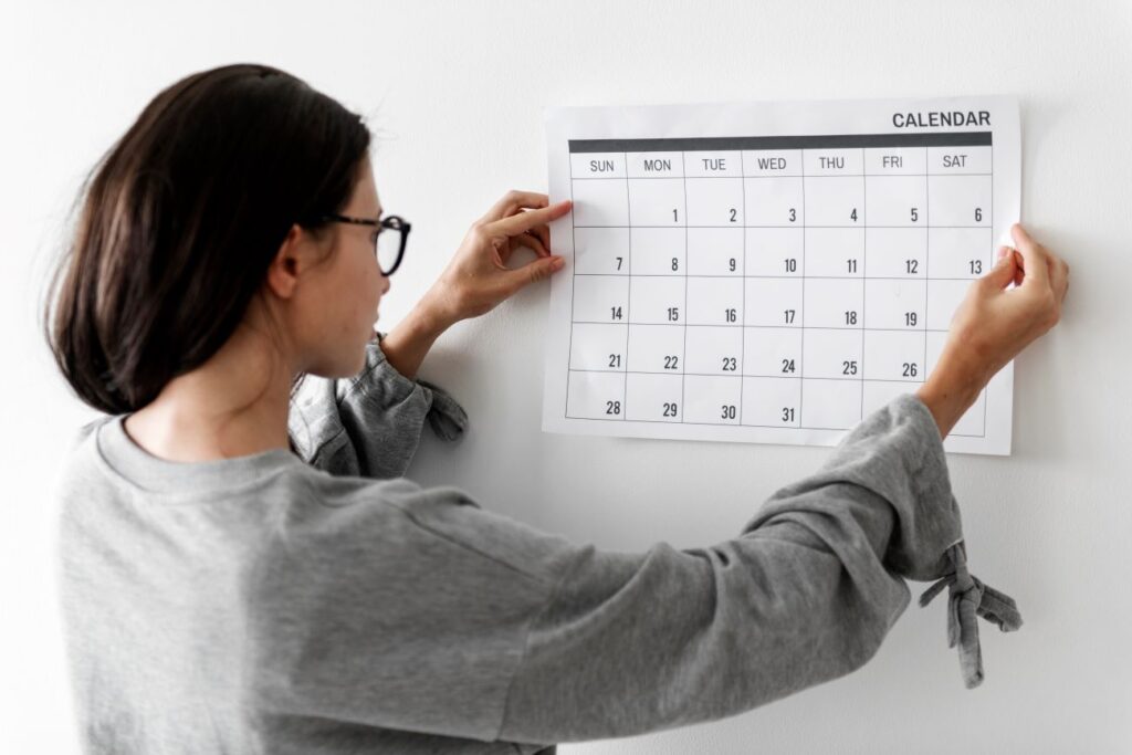 A woman looking at a calendar